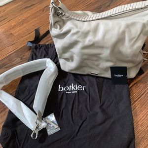 2 side zip compartments.strap to wear crossbody. No marks scratches.